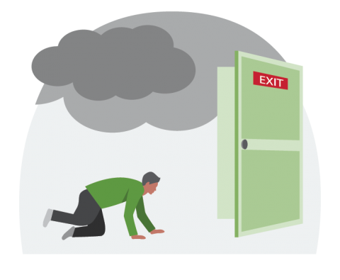A man crawling low under smoke toward an exit.